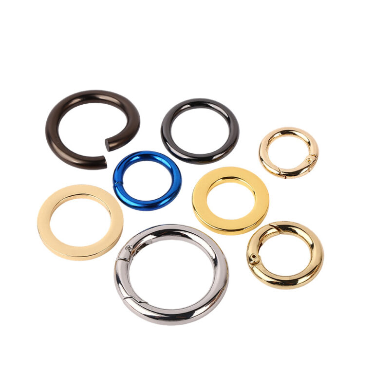Collection of metal o-rings in black, gold, silver, and blue finishes for bag hardware
