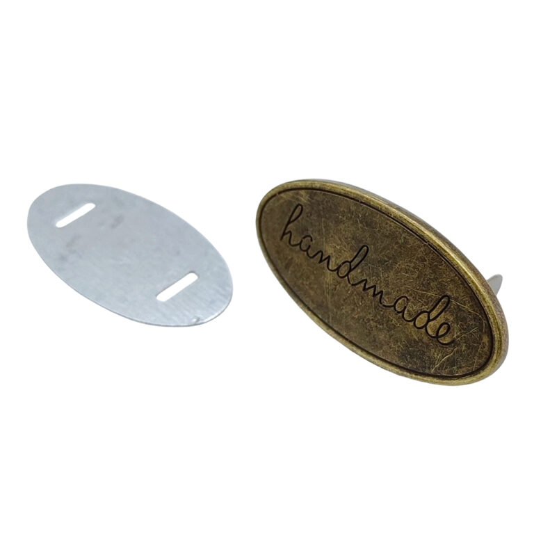 Oval Metal Handmade Label in antique brass finish for bags and crafts.