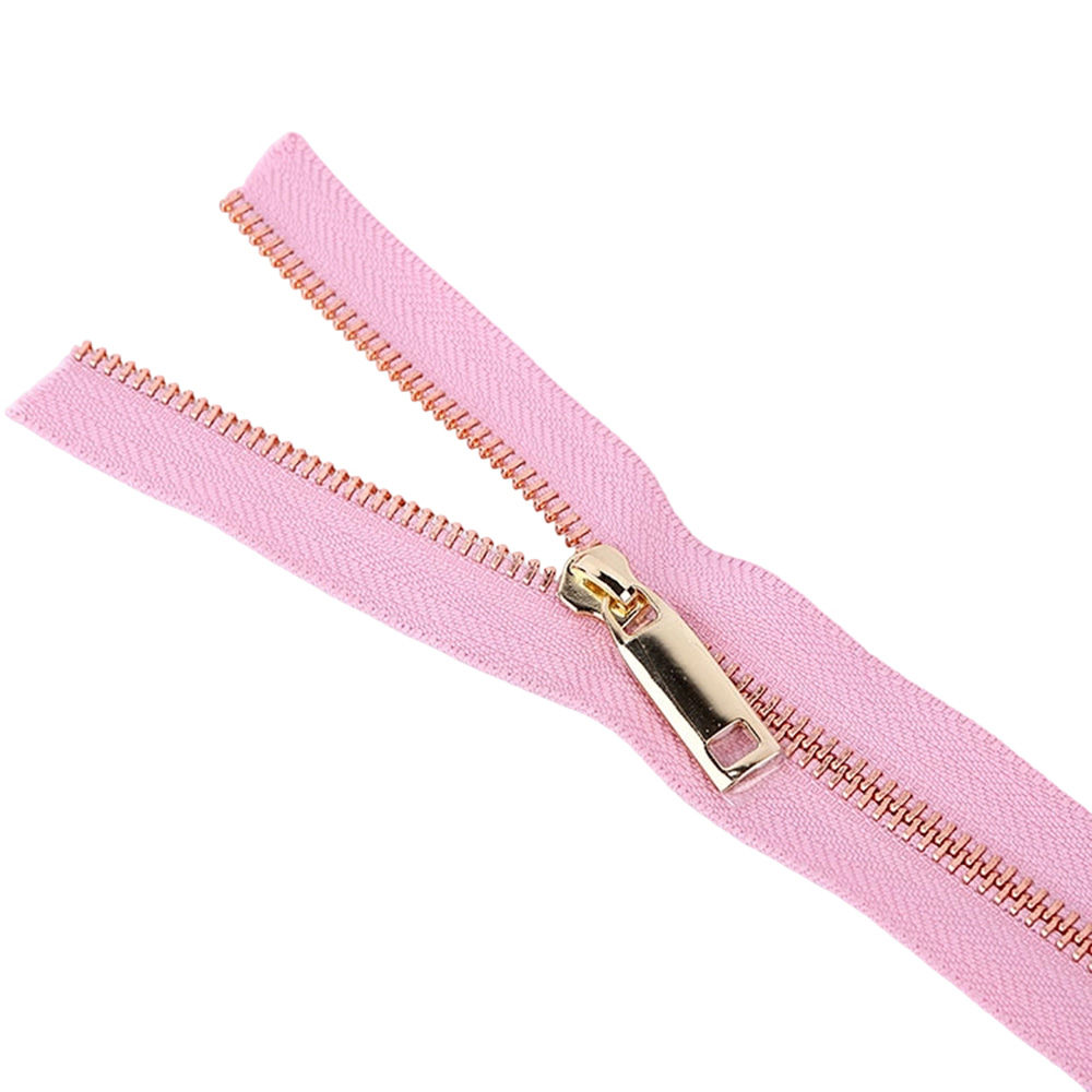 Gold heavy duty metal zipper pulls installed on an open pink continuous zipper tape.