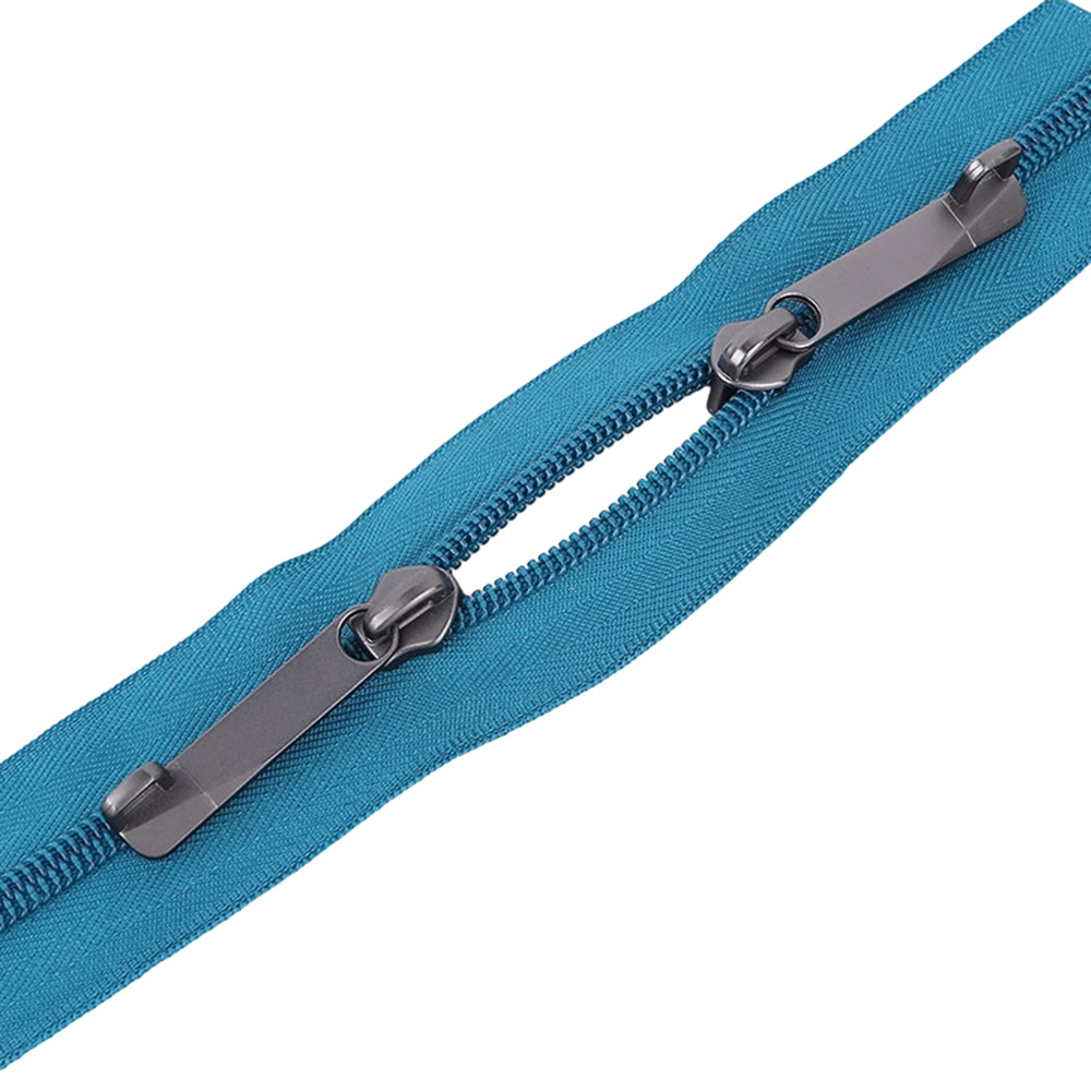 Blue explosion proof zipper for hardshell luggage showing unique dual interlocking track with two custom metal sliders