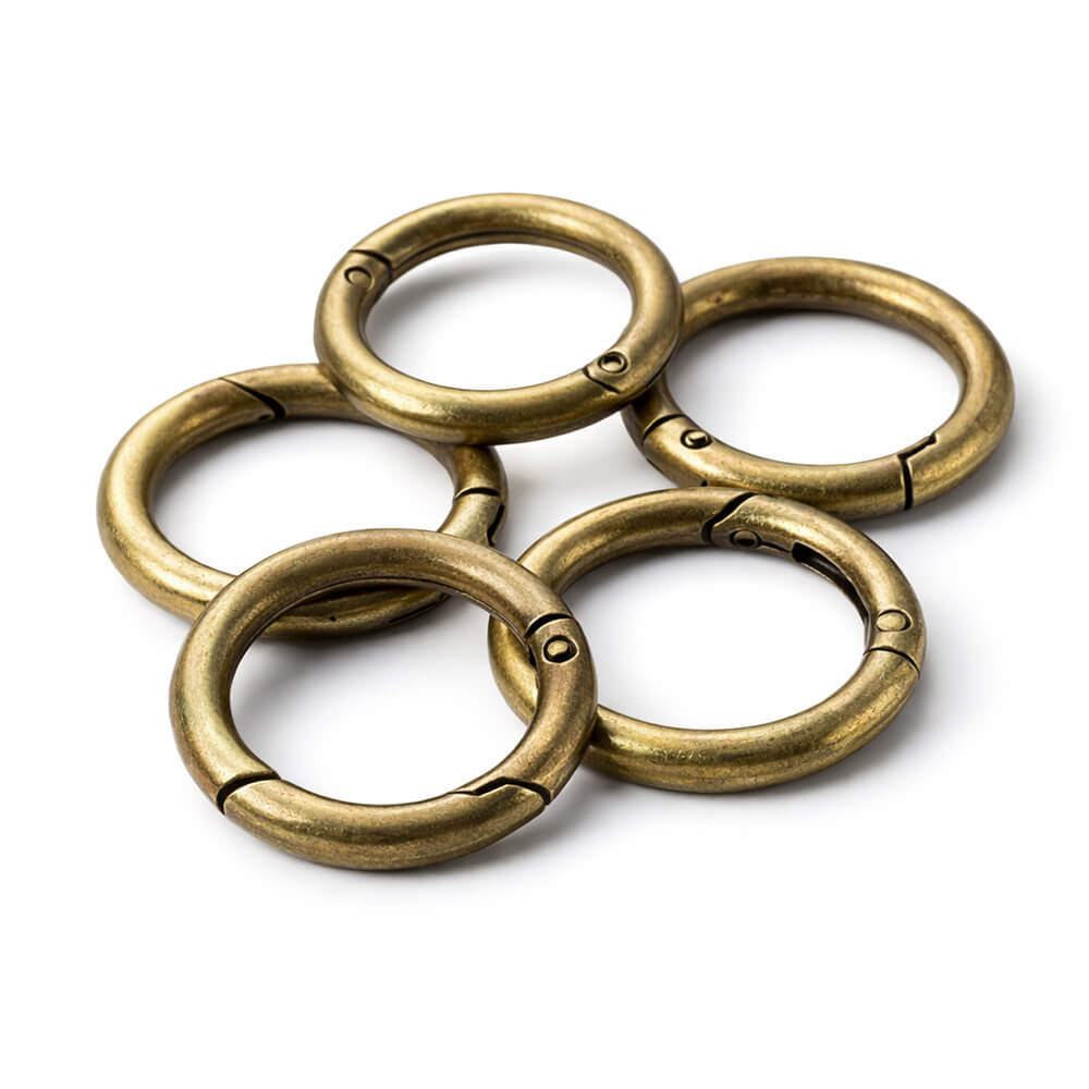 Antique brass round spring snap clips for vintage style purse strap hardware replacement.