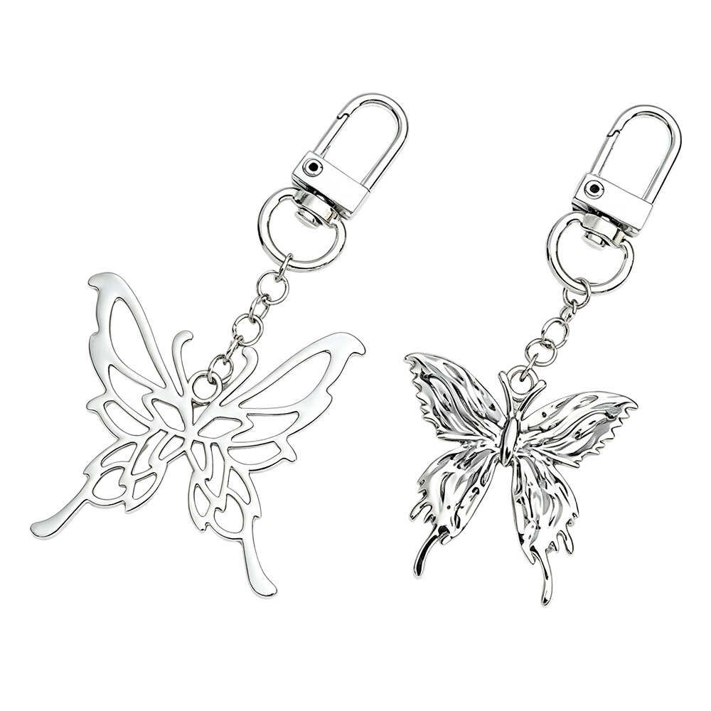 Two stylized butterfly bag charms from a bulk fashion bag accessory supplier, showcasing diverse zinc alloy die casting designs.