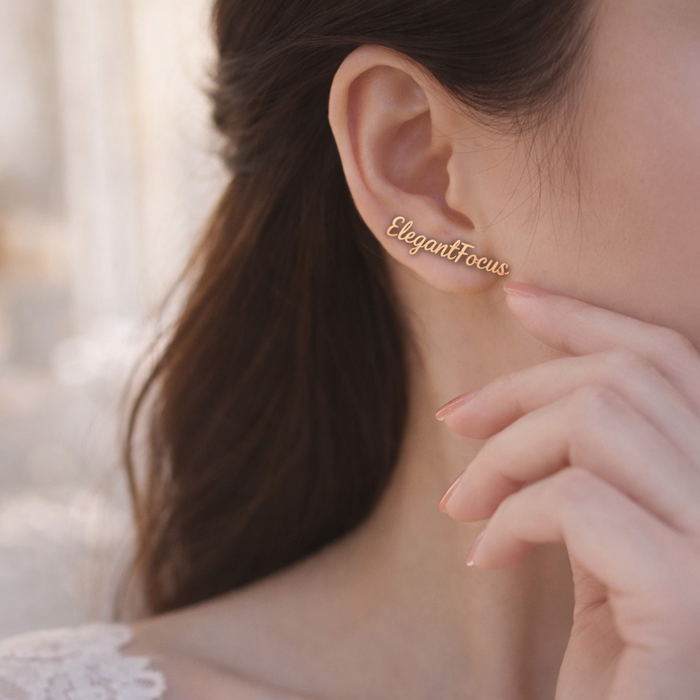 A woman wearing custom name stud earrings for women with a dainty script design.