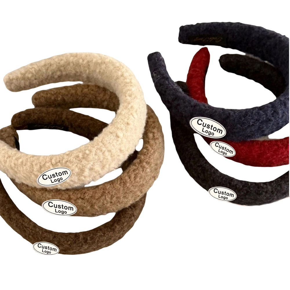 A collection of colorful plush headbands featuring small metal logo charms from a custom headband metal logos factory.