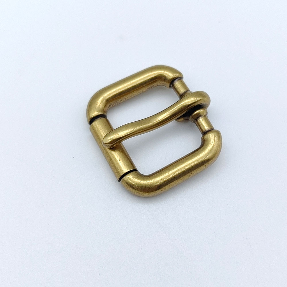 Center bar roller buckle with antique brass plating for adjustable straps.