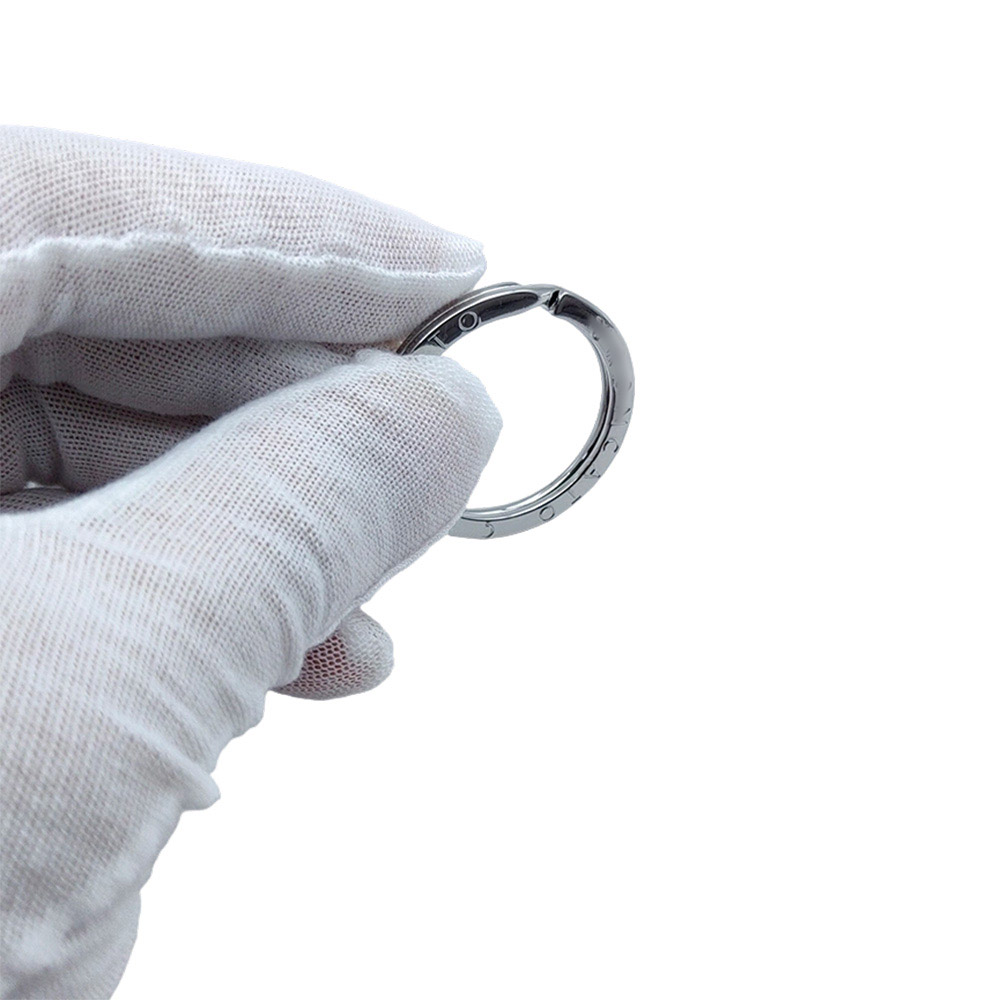 Custom logo flat key ring held in hand showcasing nickel plated key ring finish.