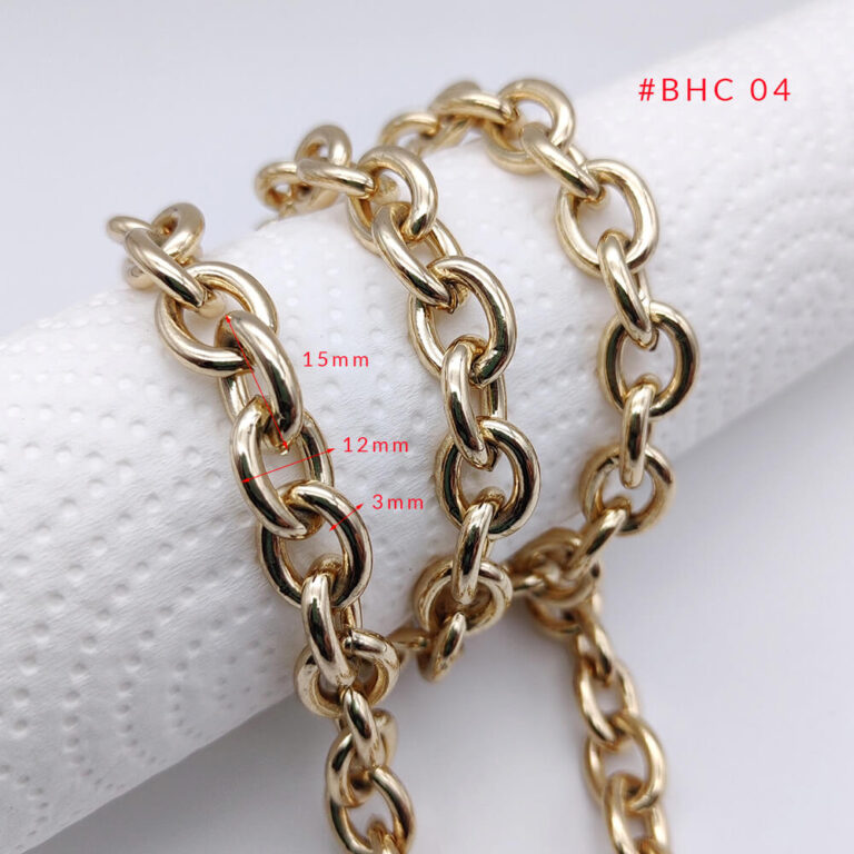 Close-up of thick oval link metal bag chain with a high-quality polished light gold finish.