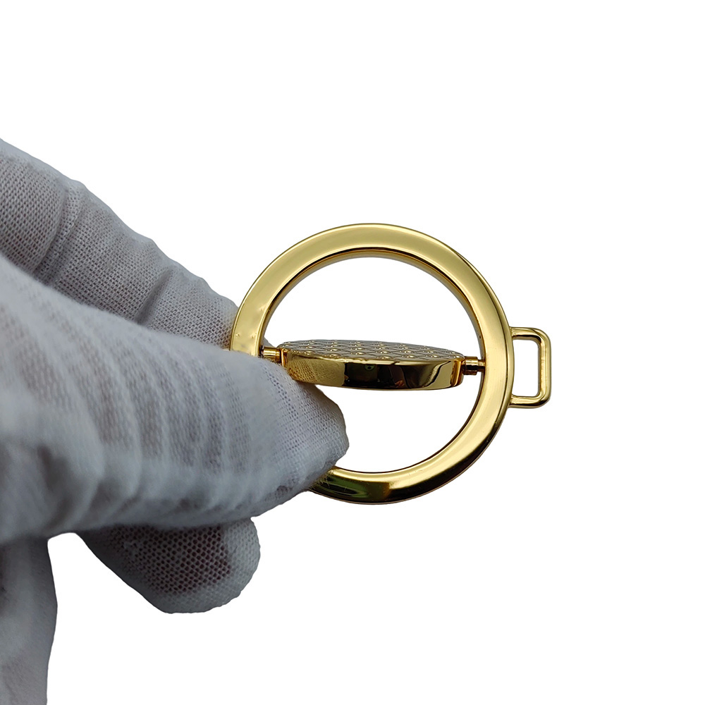 Side view demonstrating the rotating swivel joint action of the metal logo hardware for bag straps.