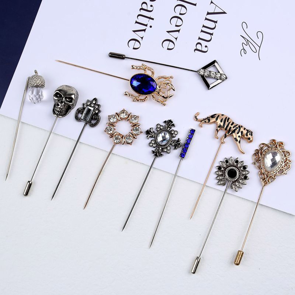 Collection of custom metal lapel stick pins in floral, gemstone, skull, and animal designs