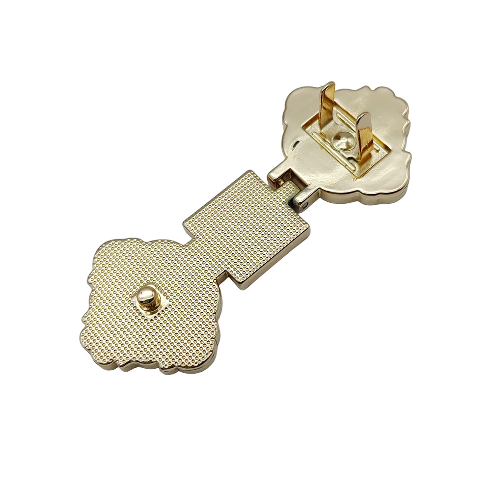 Back view of a gift box clasp showing mounting plate, hinge and fastening stud