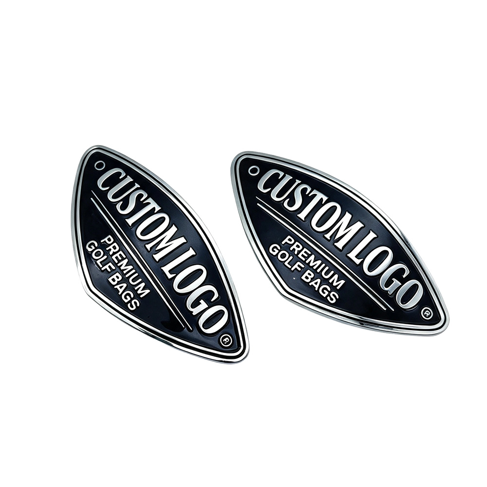 Golf bag nameplate pair highlighting precision die casting on curved shield profile