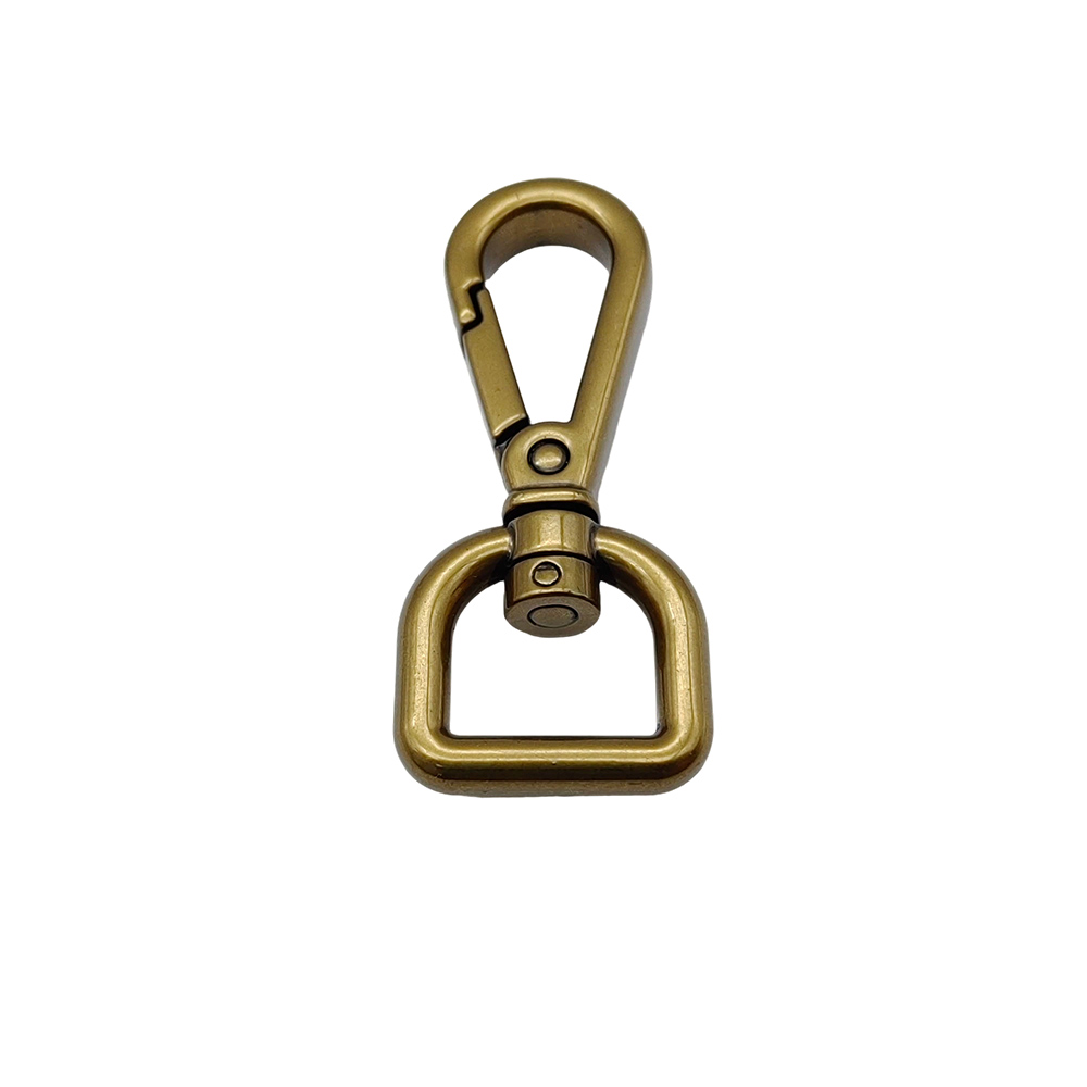 Front view of antique brass trigger snap hook showing thumb gate and swivel shaft