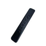 Angled black custom metal logo emblem for handbags showing its slim dimensional profile