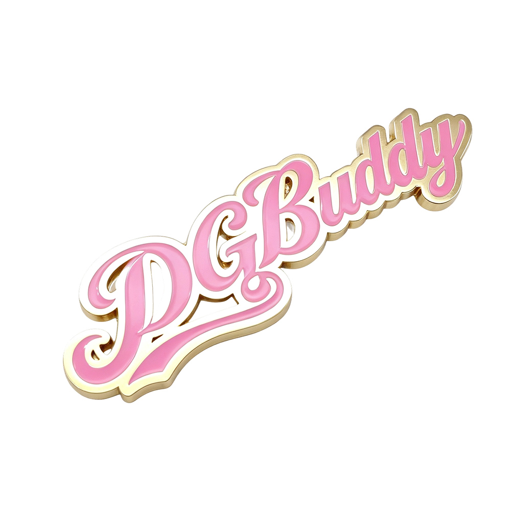 Custom metal logo plate at an angle showing 3D raised letters and polished gold edge