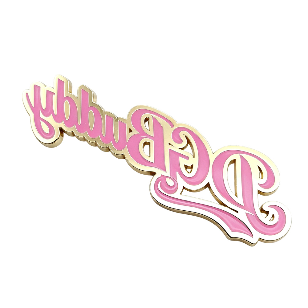Back view of a custom metal nameplate for bags showing reverse lettering and mounting pins