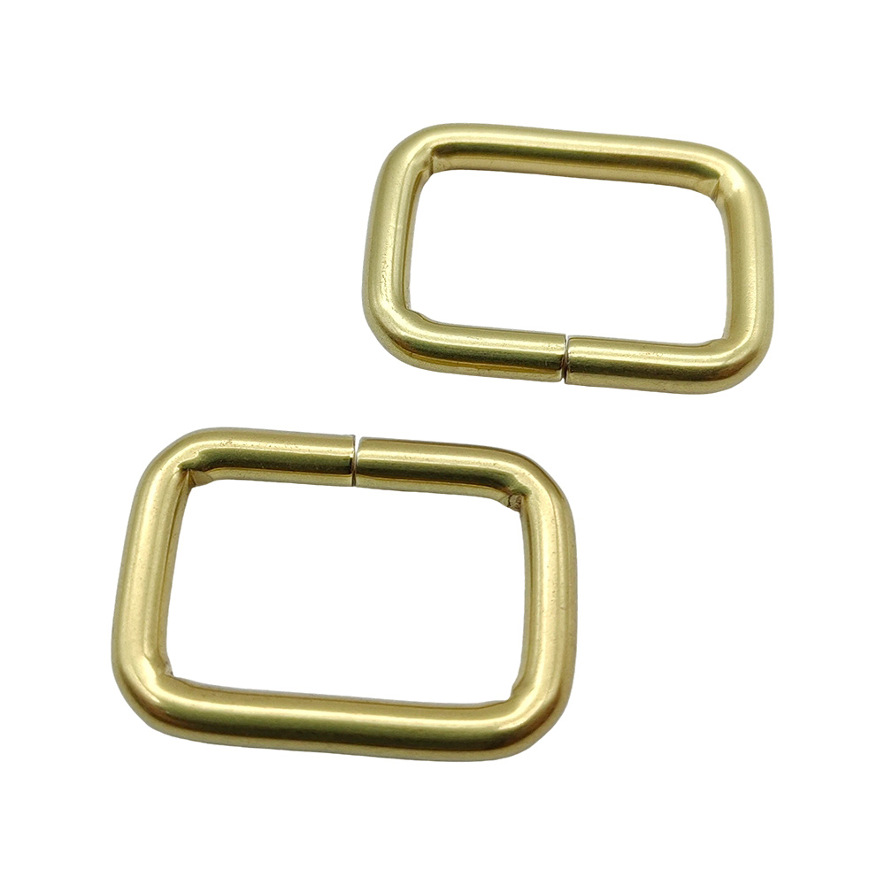 Pair of gold iron rectangle rings for bag straps showing weld detail