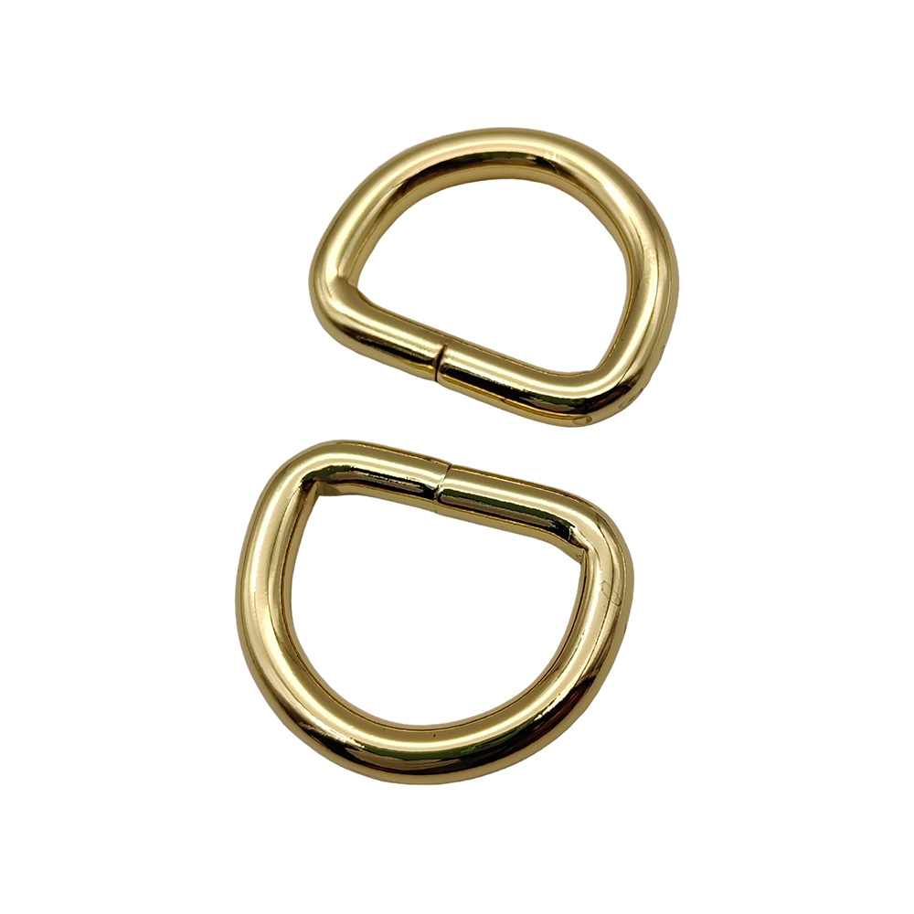 Two gold D ring hardware pieces stacked to show consistent sizing