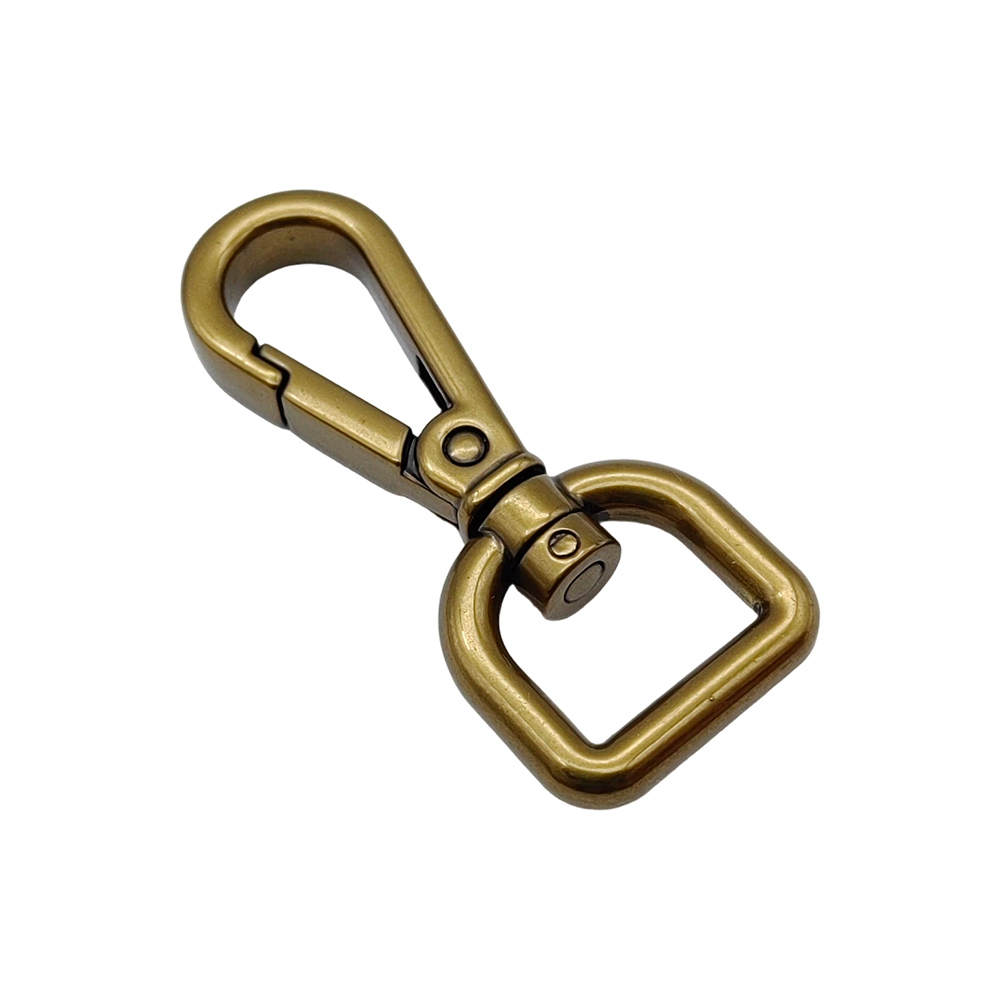 Antique brass swivel snap hook with square D-ring base, diagonal studio view on white