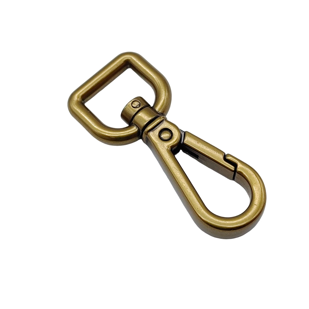 Aged brass bag swivel clasp at an angle, showing the antique finish in the crevices