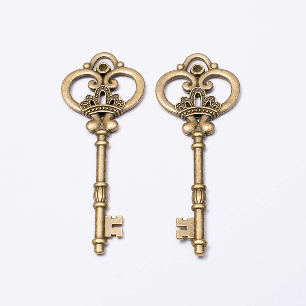 Pair of antique bronze crown skeleton keys, detailed filigree bow, 82 mm length