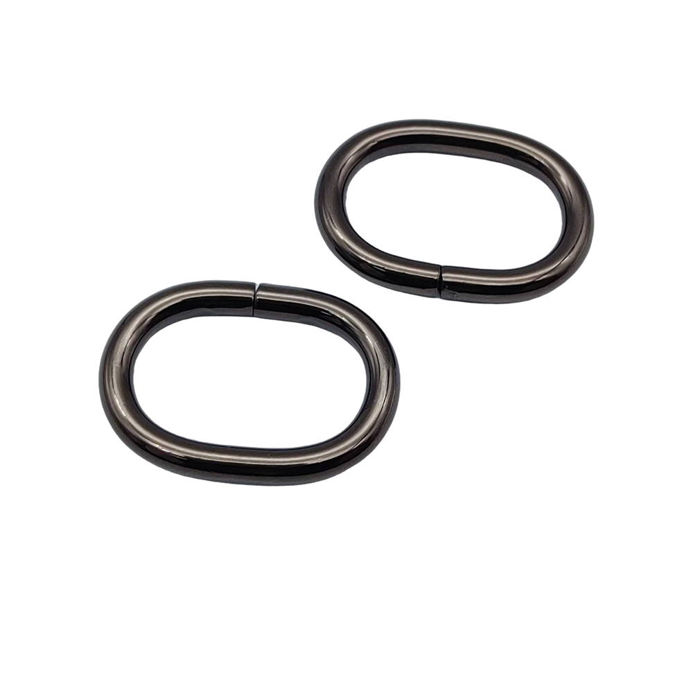 Two gunmetal oval iron rings laid flat together, weld seams visible on the wire