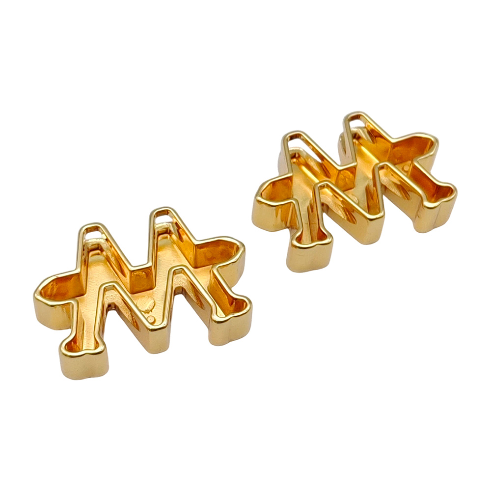 Close-up of two gold airplane metal logos showing surface smoothness and edge quality
