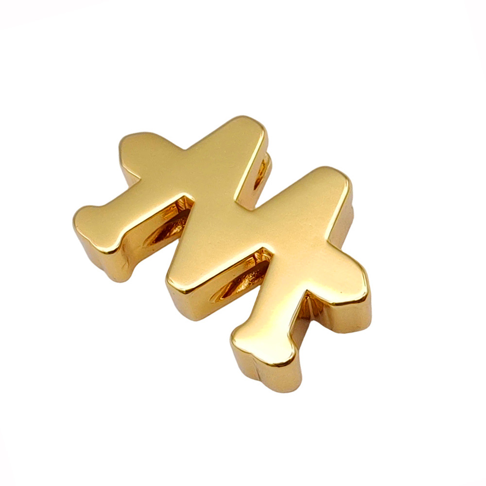 Slightly tilted zinc alloy airplane logo showing plating reflection and surface quality