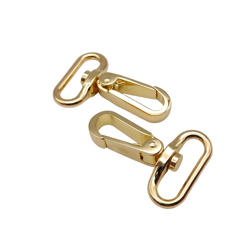 Multiple gold-tone metal snap hooks for bags and accessory hardware