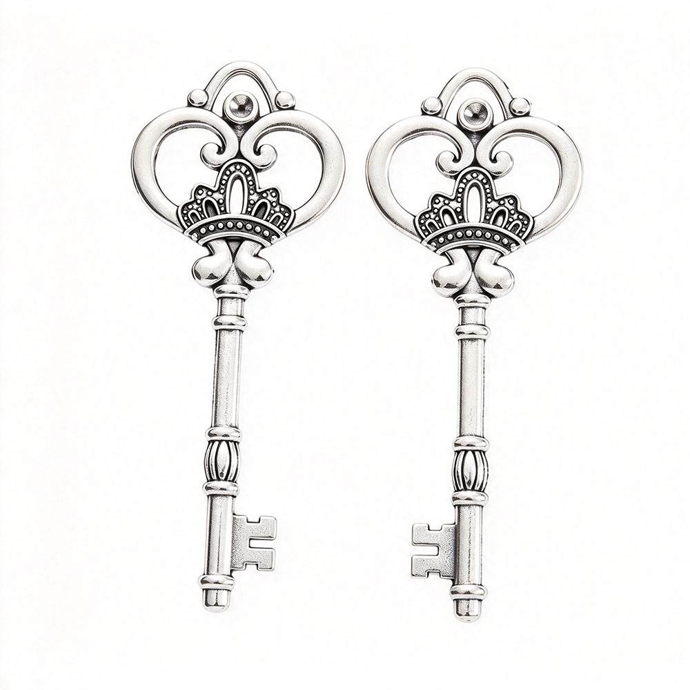 Two polished silver zinc alloy crown keys with heart filigree bow