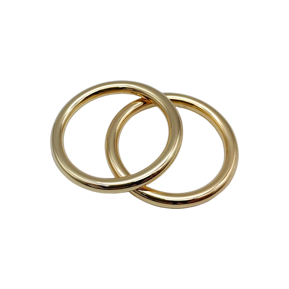 Polished gold zinc alloy O rings overlapping to show surface finish